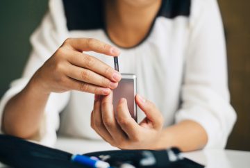 photo of a woman checking her blood sugar