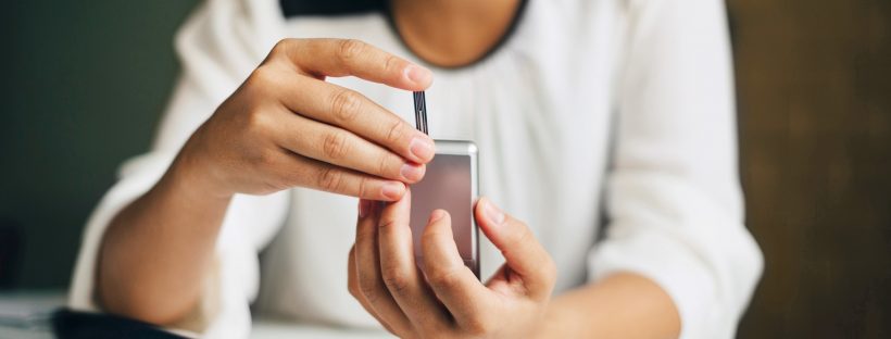 photo of a woman checking her blood sugar