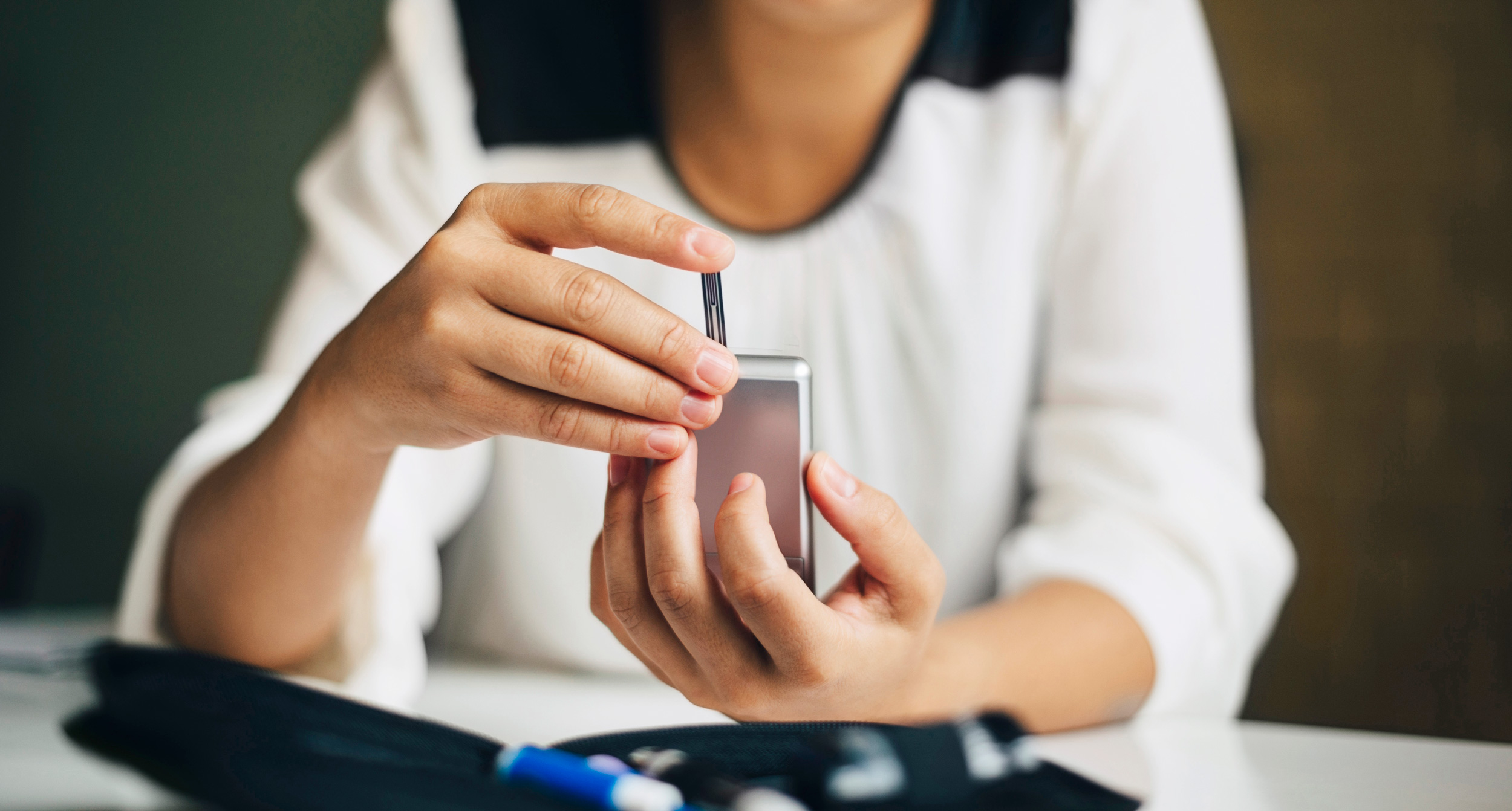 photo of a woman checking her blood sugar