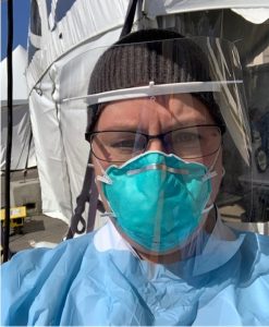 Picture of Kathy Gorall wearing protective equipment and gown