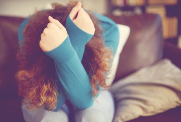 Picture of a woman holding her head in her hands