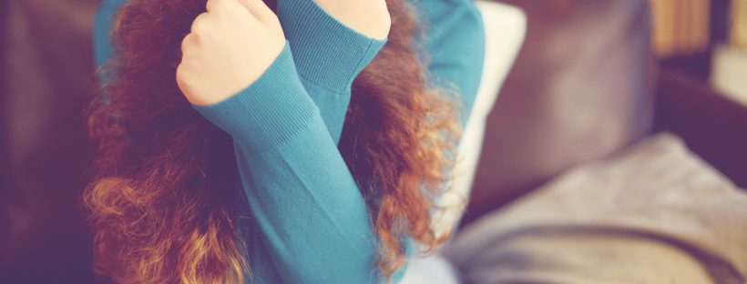 Picture of a woman holding her head in her hands