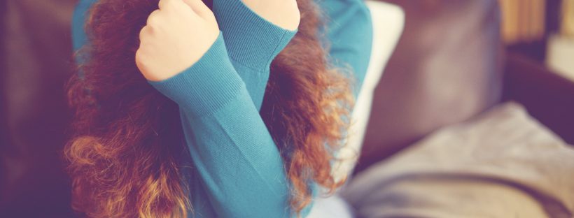 Picture of a woman holding her head in her hands