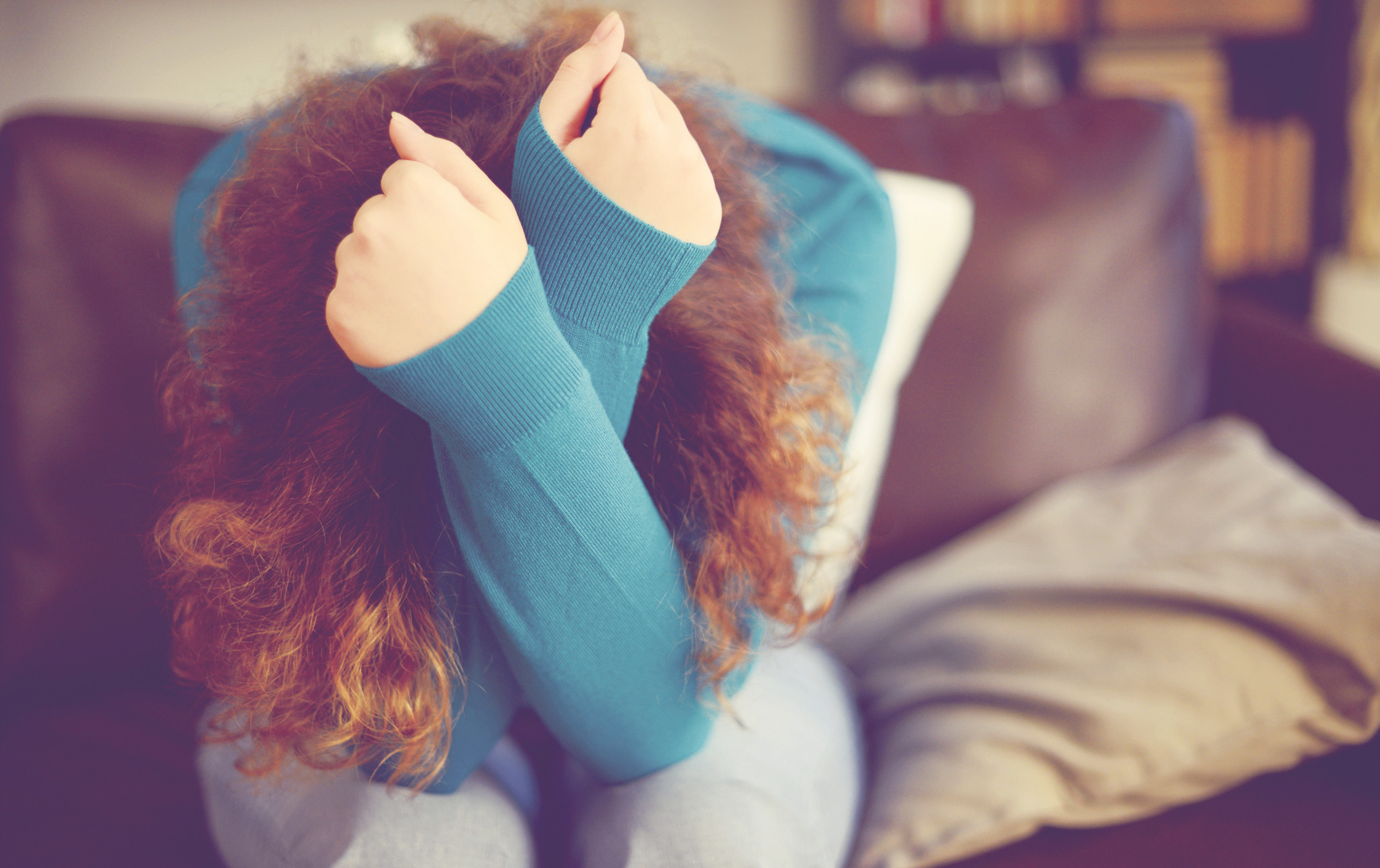 Picture of a woman holding her head in her hands