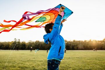 Picture of a boy flying a kite in a park