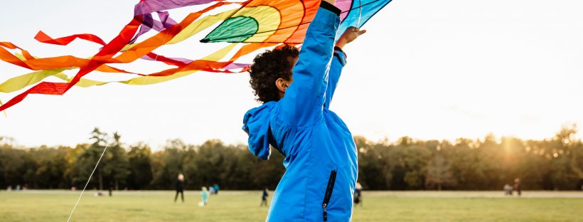 Picture of a boy flying a kite in a park