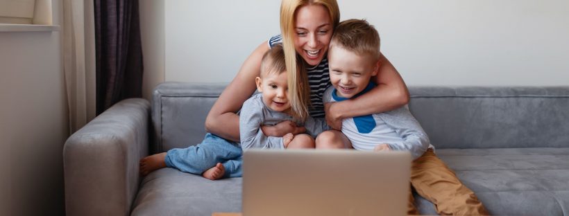 Mother sitting with her two children in front of a computer