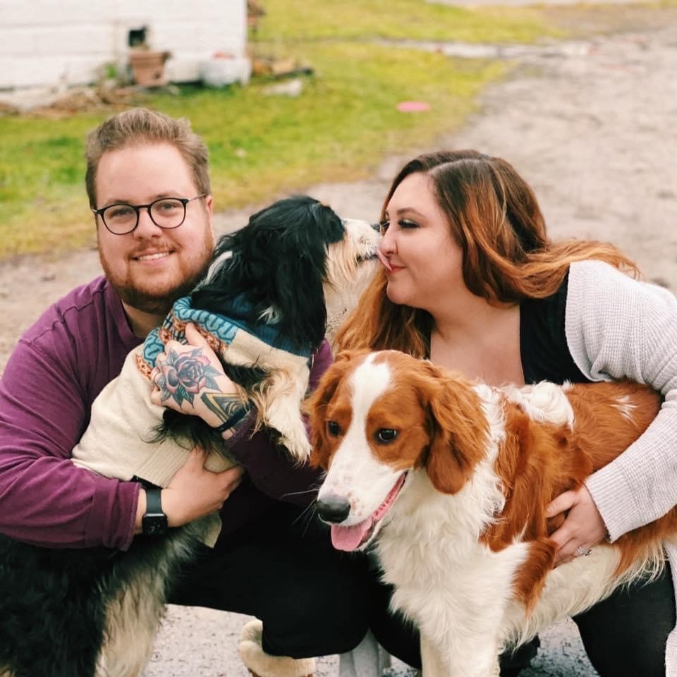 Picture of a man and a woman each holding a dog