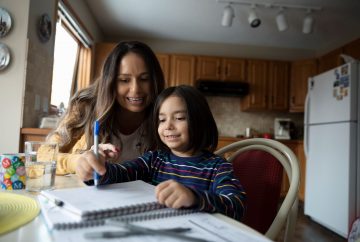 Mother helping child do homework