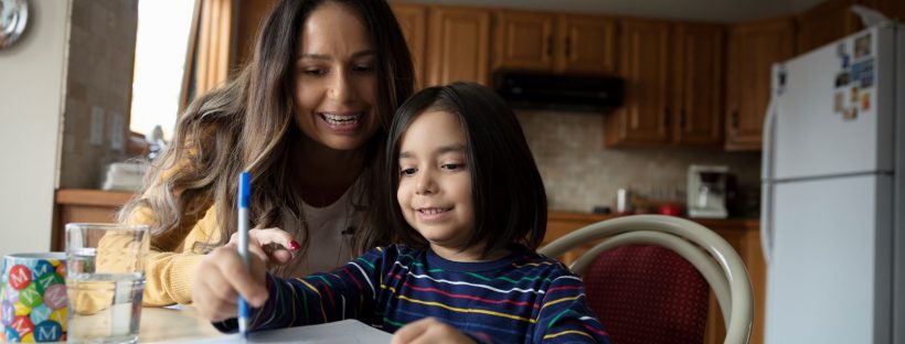 Mother helping child do homework