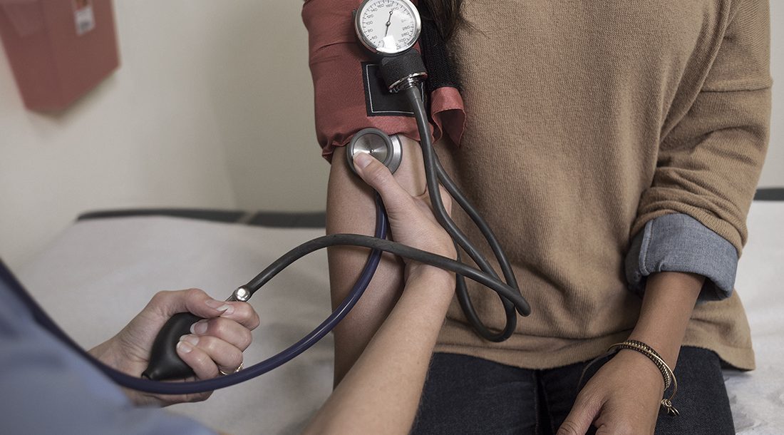 Picture of a woman getting her blood pressure taken