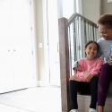 Woman sitting on the step with her granddaughter