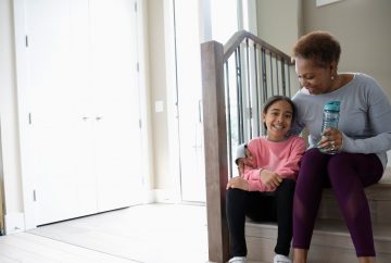 Woman sitting on the step with her granddaughter