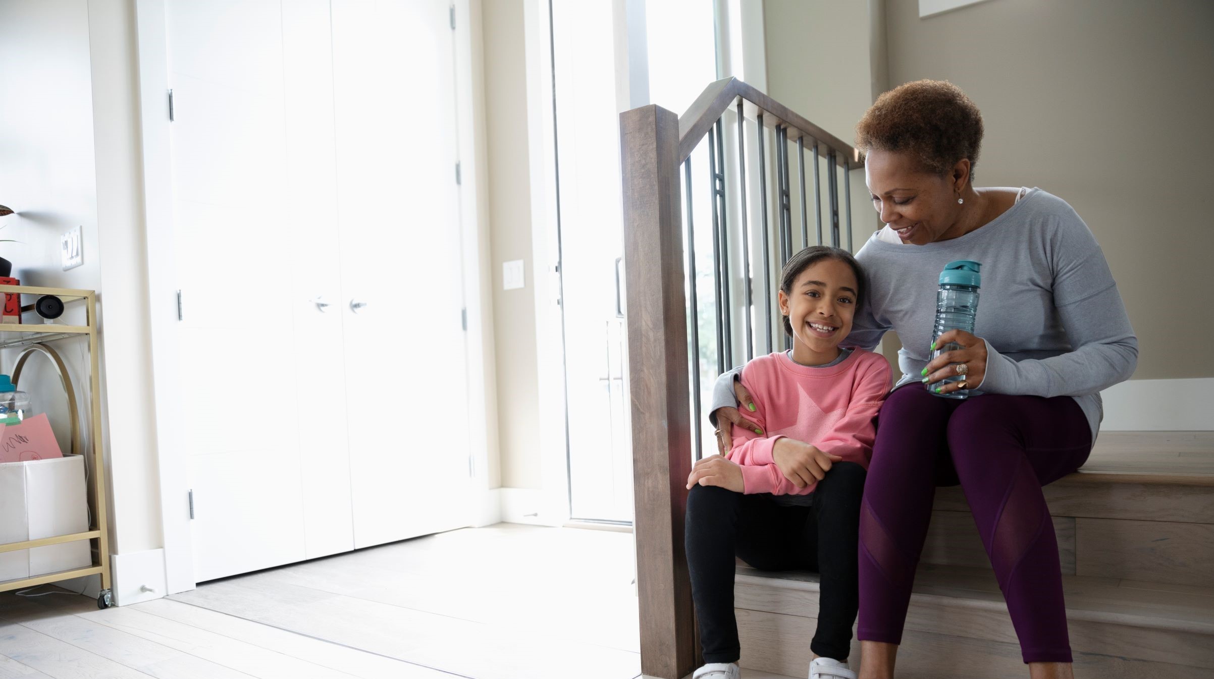 Woman sitting on the step with her granddaughter