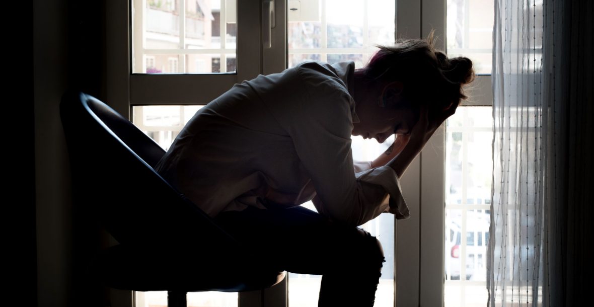 Picture of woman holding her head in her hands