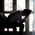 Picture of woman holding her head in her hands