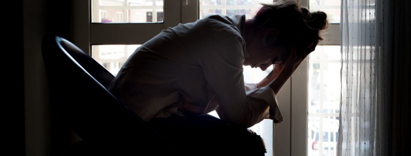 Picture of woman holding her head in her hands