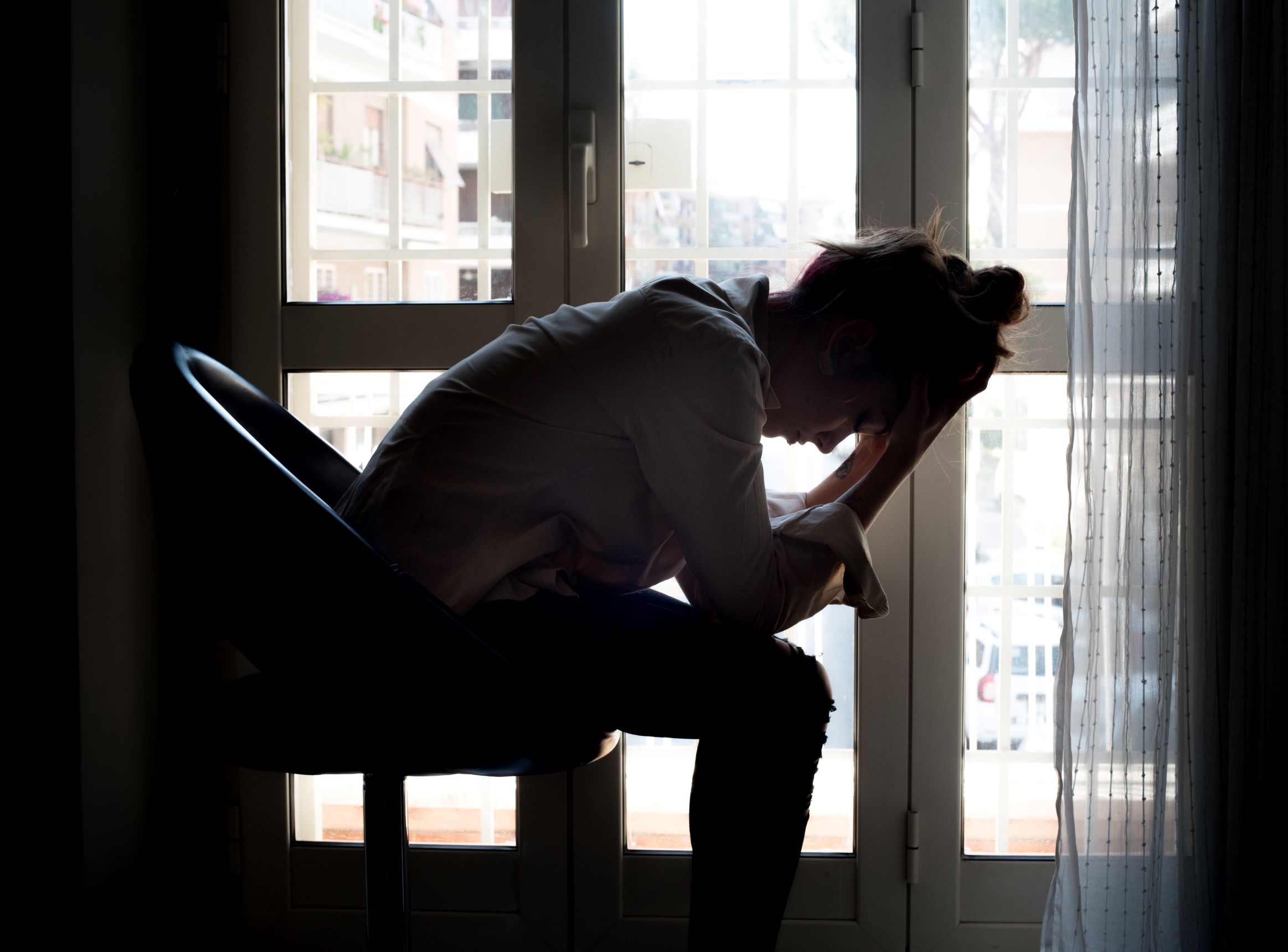 Picture of woman holding her head in her hands