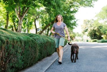 Picture of a woman walking her dog