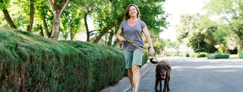 Picture of a woman walking her dog