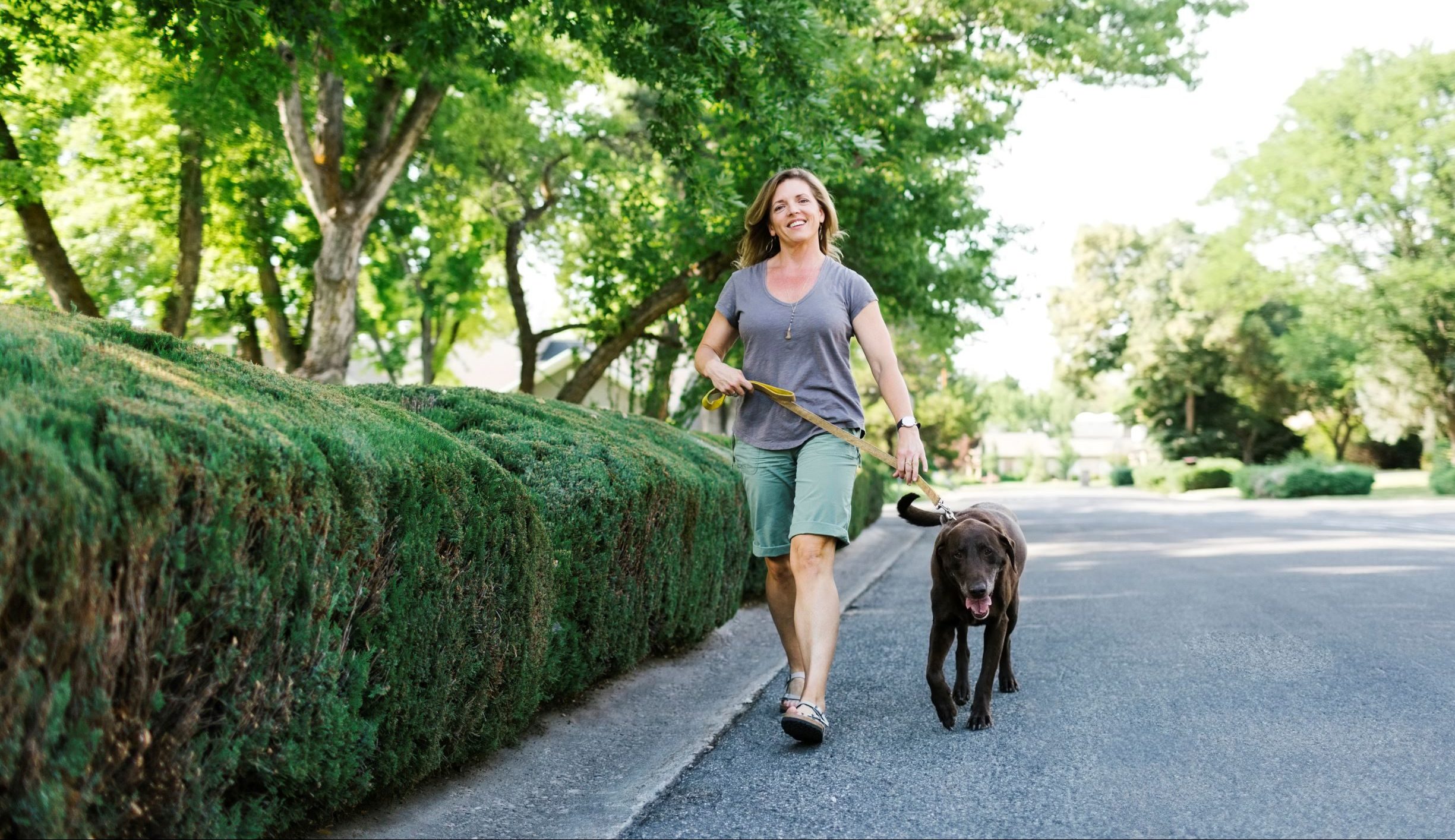 Picture of a woman walking her dog