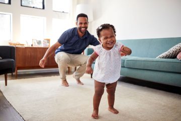 Picture of a dad and baby girl dancing