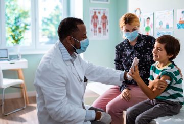 Boy giving a high five to doctor