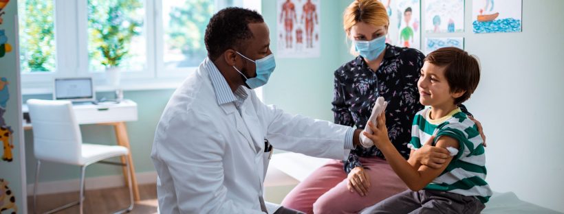 Boy giving a high five to doctor