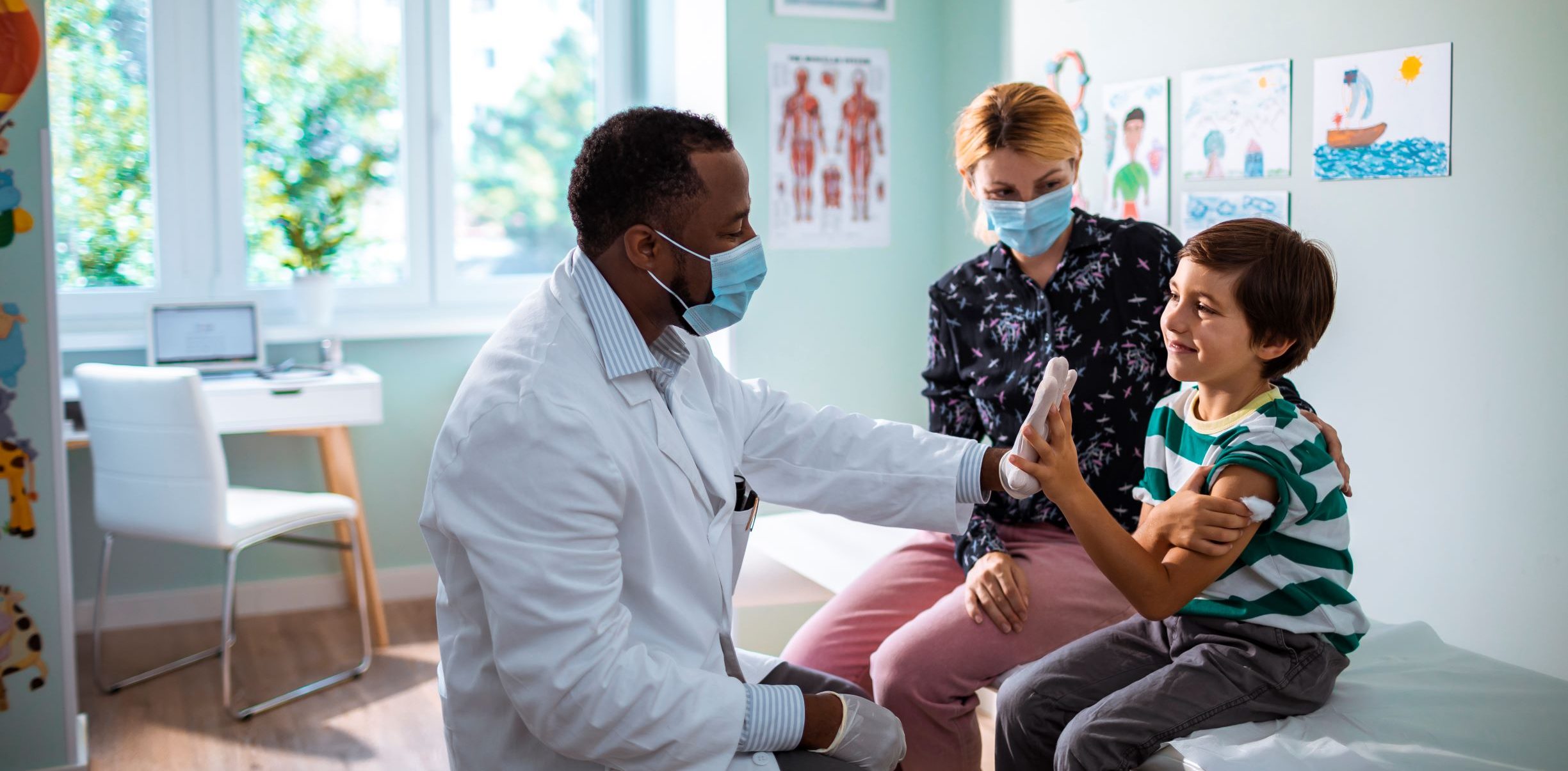 Boy giving a high five to doctor