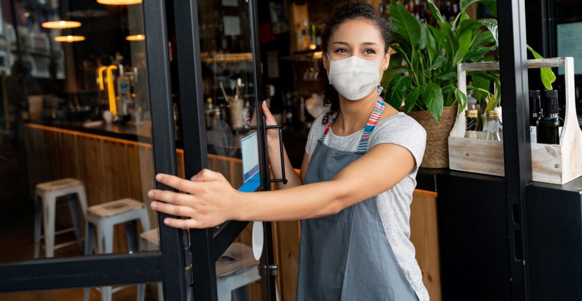 Picture of woman in mask opening door