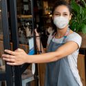 Picture of woman in mask opening door