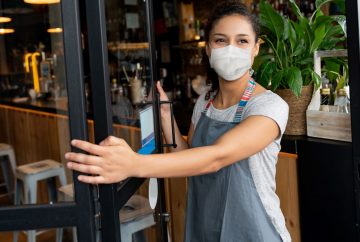 Picture of woman in mask opening door