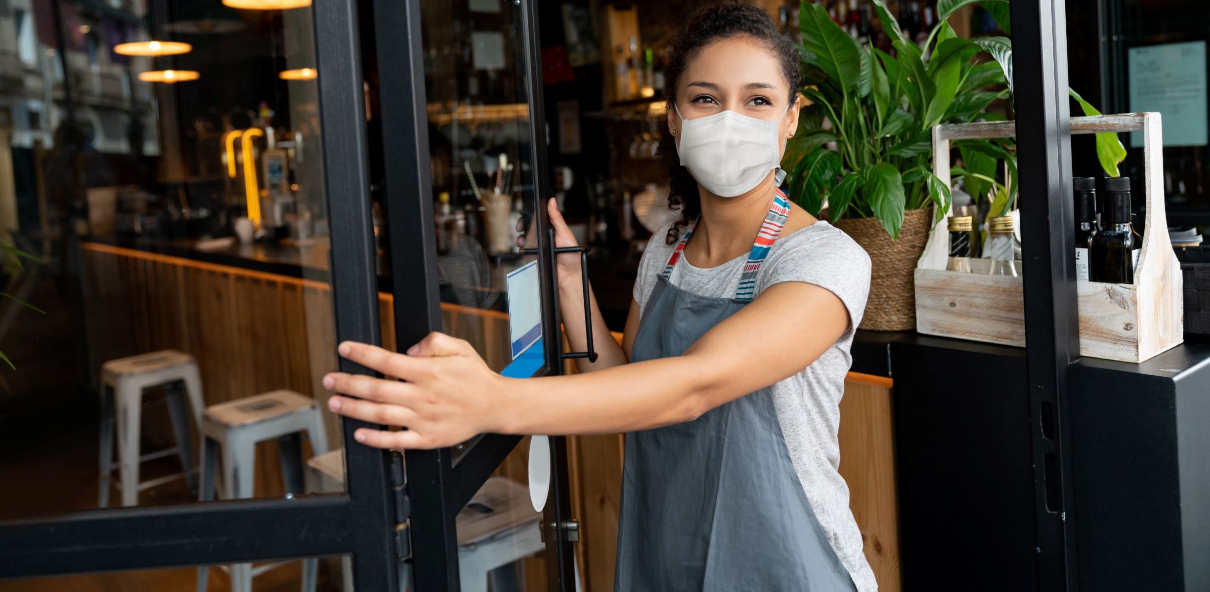 Picture of woman in mask opening door